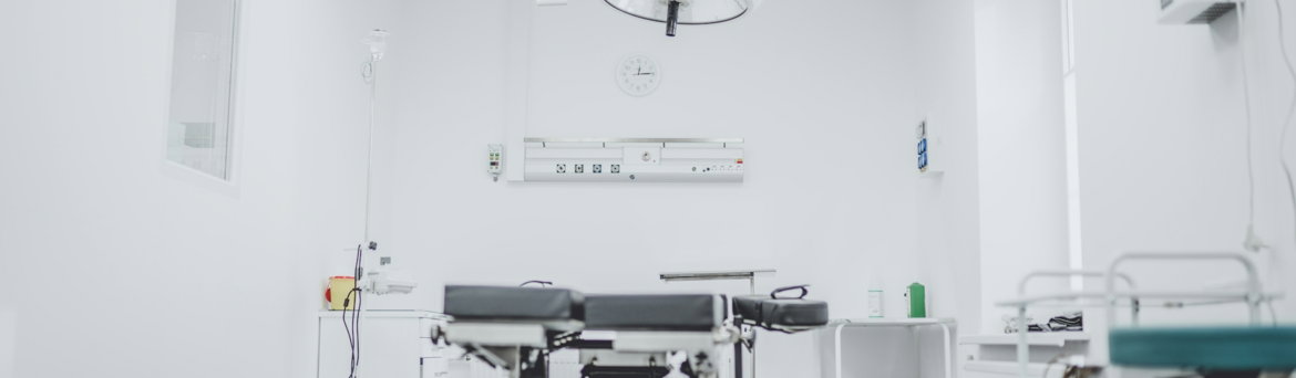 black and white hospital bed in the middle of interior building