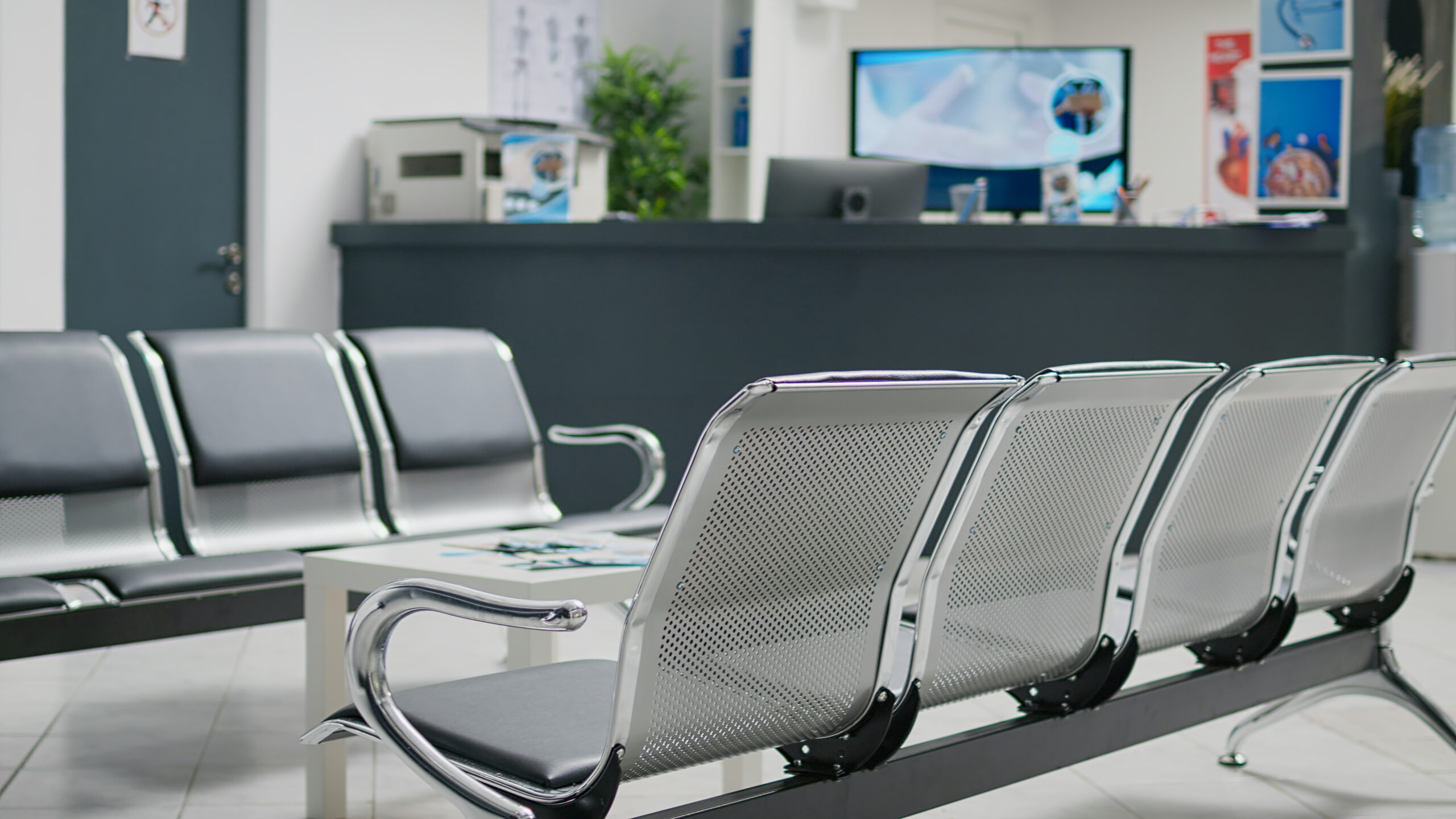 Empty hospital reception desk in waiting area lobby at medical health center, used to help patients with appointments and healthcare insurance. Clinical waiting area with counter.